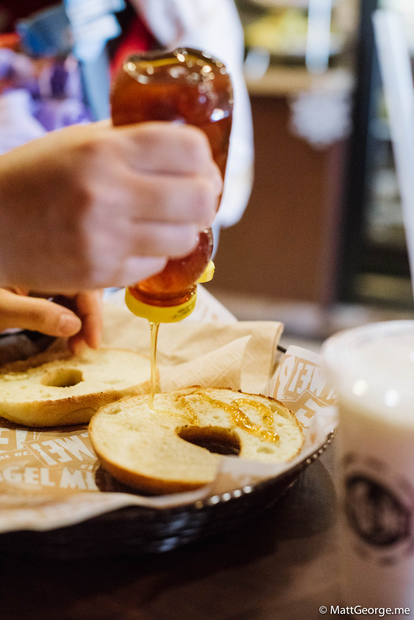 Honey being poured on bagels