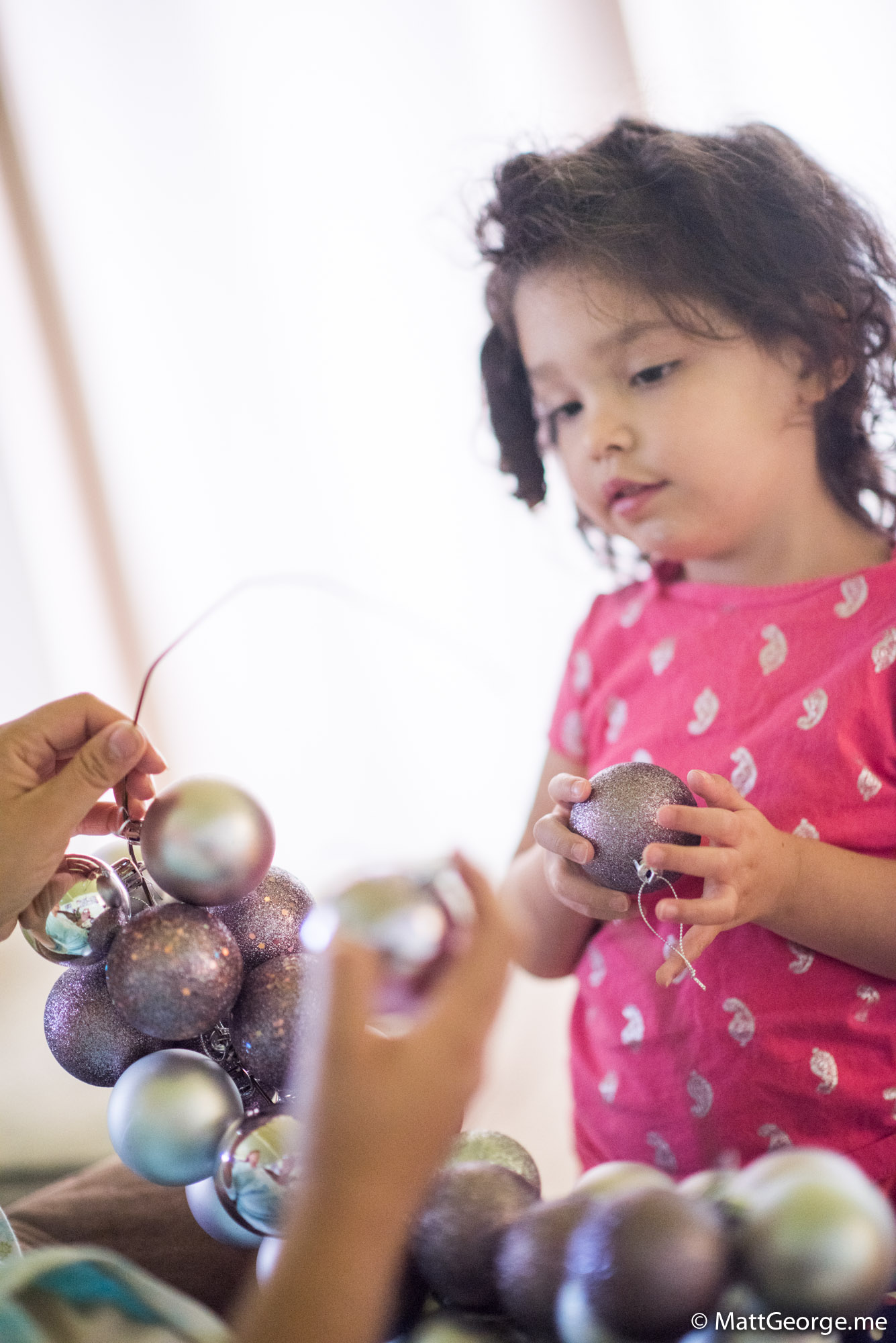 Bella Watching Mom Make a Christmas Bulb Ornament Wreath