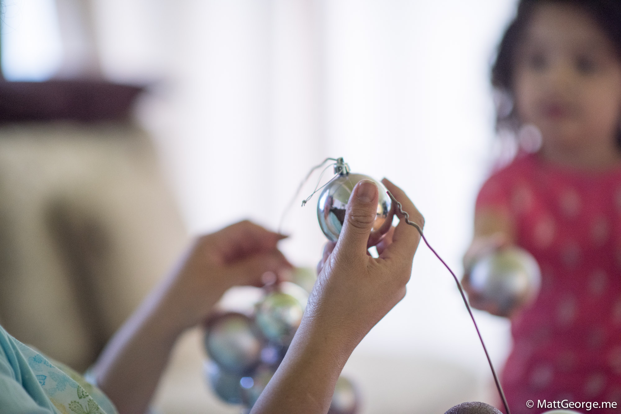 Mom Putting the Silver Ornament onto the Wire for the Christmas Wreath
