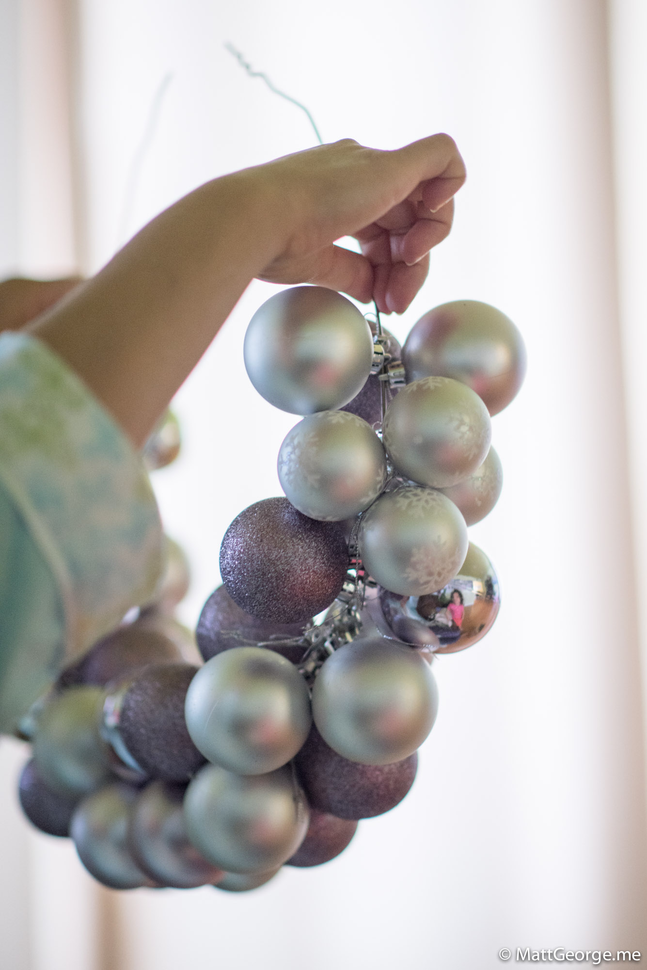 Mom Holding Up the Partly Finished Christmas Wreath