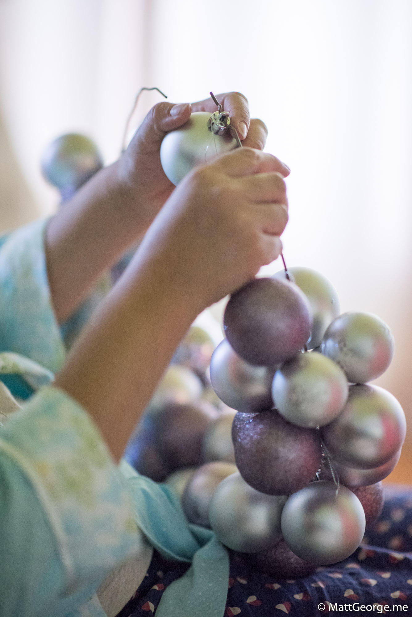 Putting the Christmas Ornaments Onto the Wire of the Wreath
