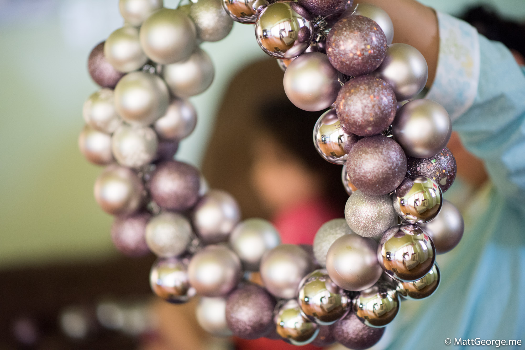 Bella Out of Focus and Framed in the Middle of an Out of Focus Christmas Wreath