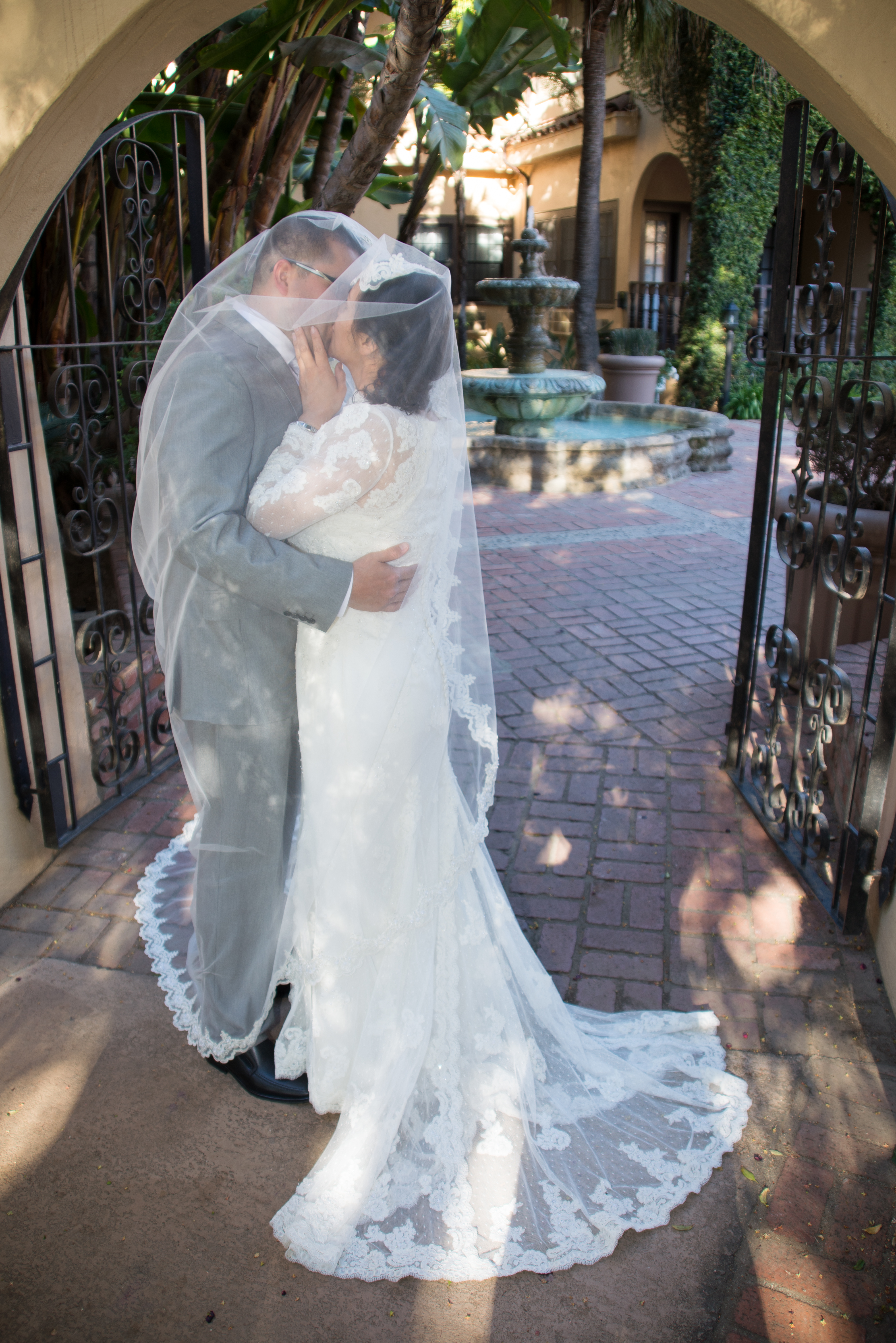 Bride Kissing Groom Under Veil