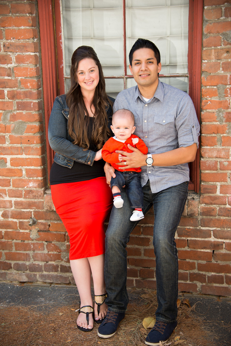 Parents with Son Portrait Against Brick Wall